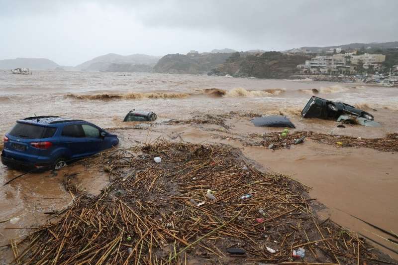 Cars are carried away by floods at the beach of the popular resort of Agia Pelagia, on the southern Greek island of Crete, follo