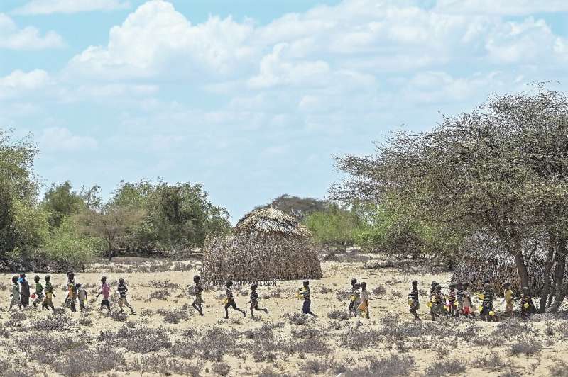 Children from Kenya's Turkana community walk in October to receive food aid; the wider Horn of Africa is facing its worst drough