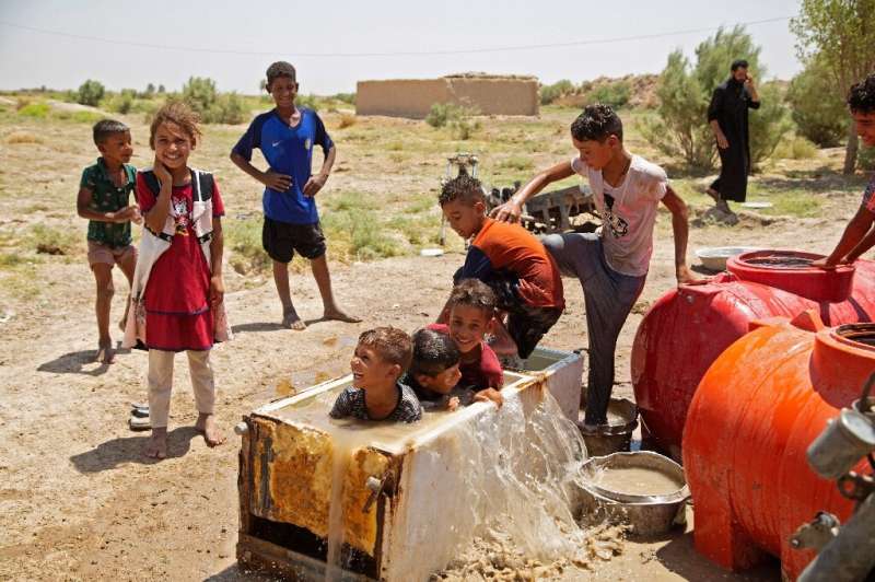 Children in al-Aghawat use a broken fridge to cool down: authorities blame drought for the current water shortages, but also dam