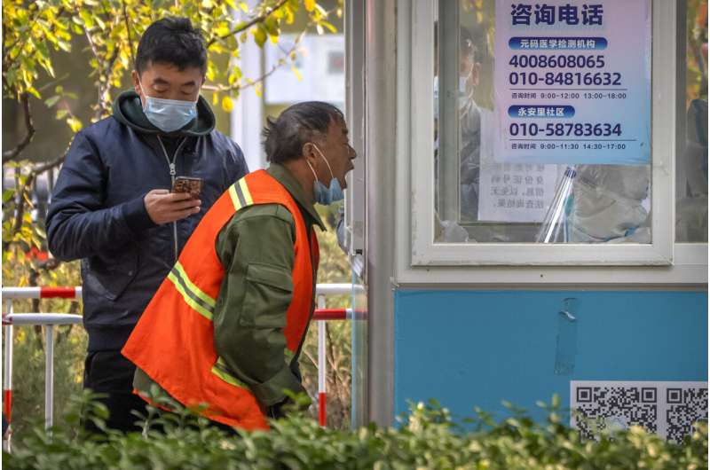China reports 10,000 new virus cases, capital closes parks