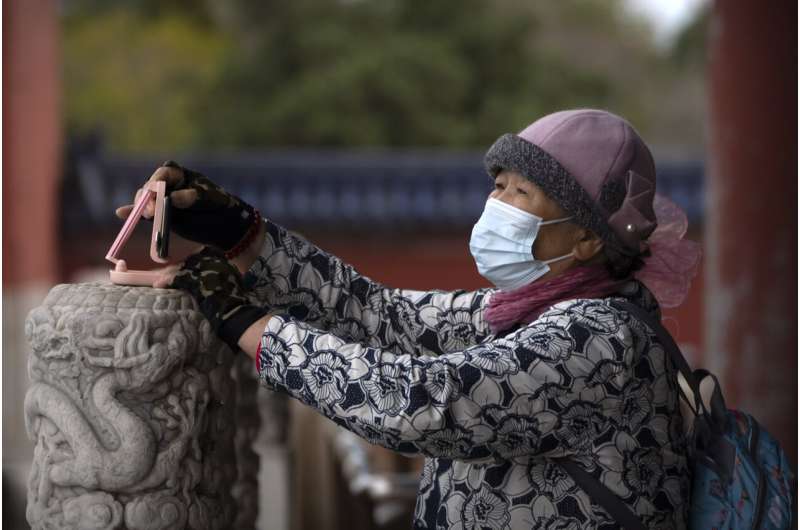 China tightens restrictions as virus cases rise