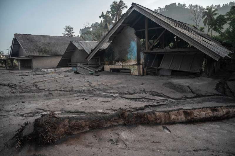 Damaged houses inundated with mud in the village of Kajar Kuning following the eruption of Mount Semeru
