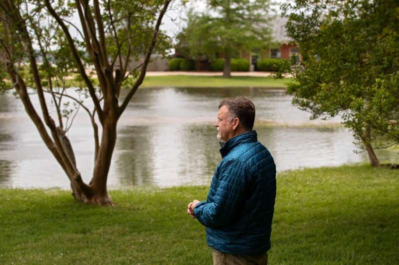 David Givens, director of archeology, looks across floodwaters at Jamestown, a key site in America's history and heritage that i
