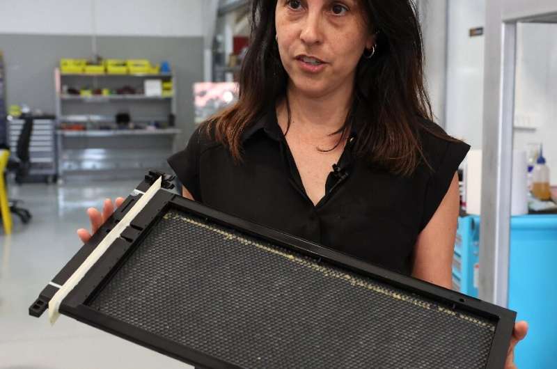 Beewise Chief Operating Officer Netali Harari demonstrates an automated beehive, part of a high-tech project located in Kibbutz Bei