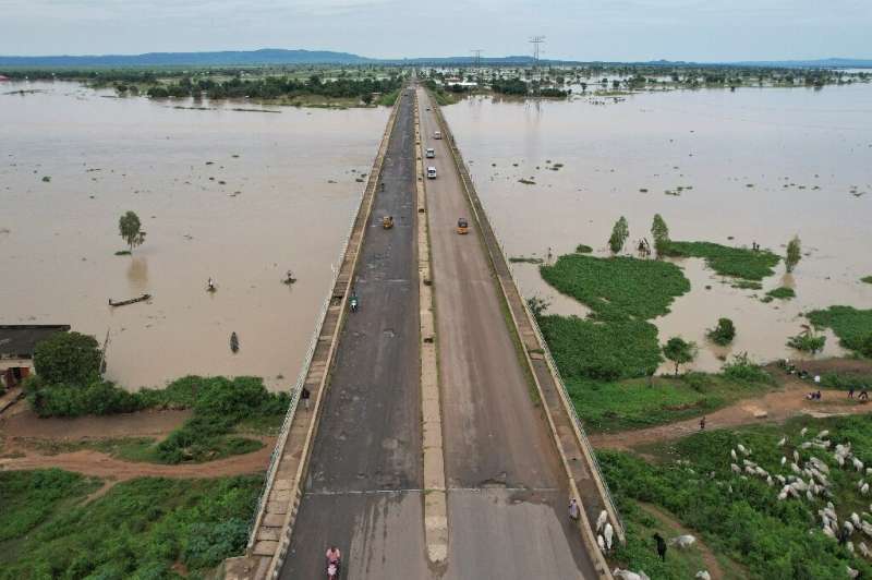 Drivers cross the Numan bridge in search of safer ground away from rising waters in Numan Community, Adamawa state in northeaste