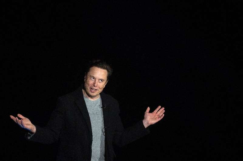 Elon Musk gestures as he speaks during a press conference at SpaceX's Starbase facility