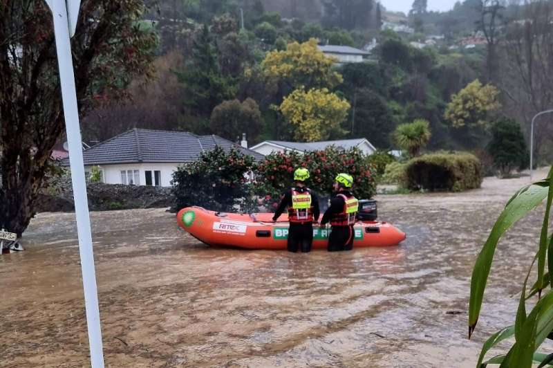Emergency personnel working in floodwaters from the overflowing Maitai River