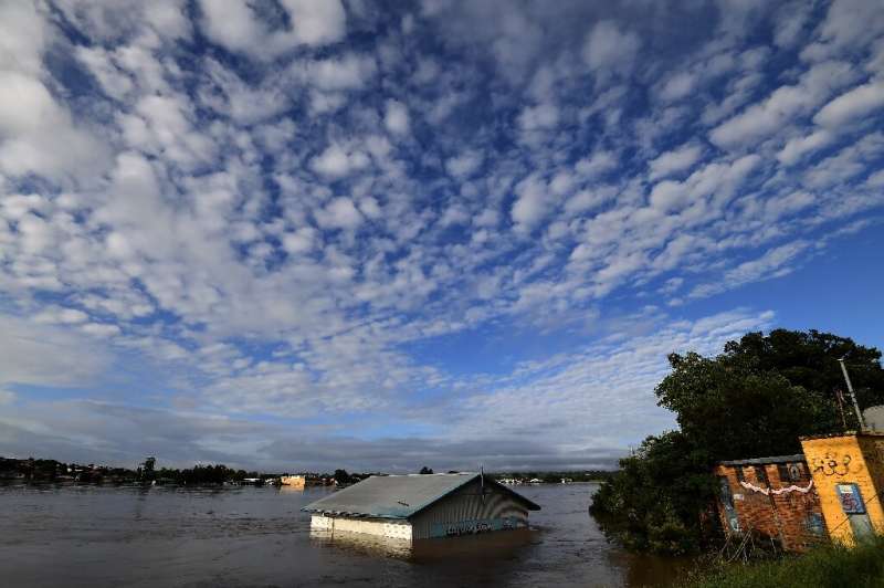 Floodwaters crashed into more towns on Australia's east coast as a deadly storm front barrelled south on Wednesday towards Sydne