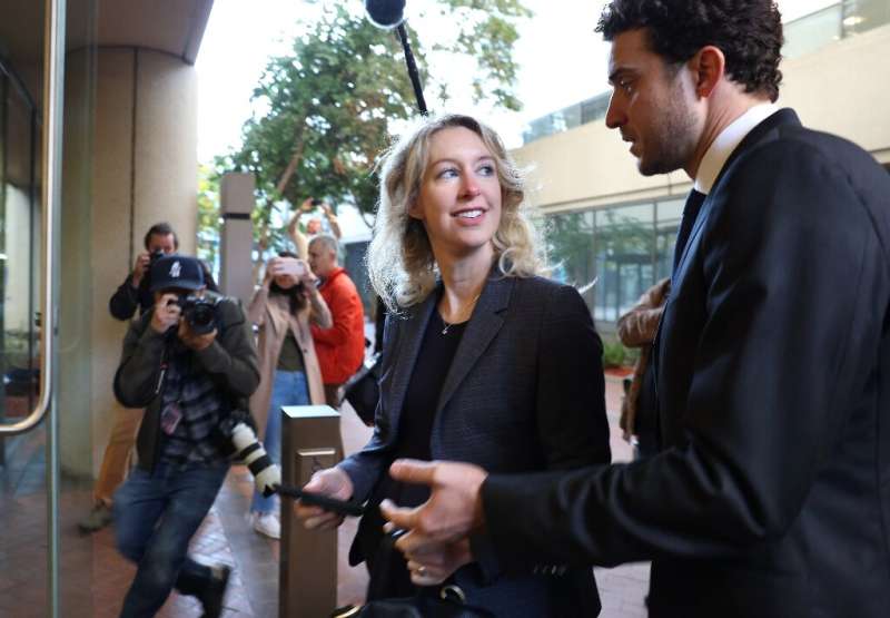 Former Theranos CEO Elizabeth Holmes arrives in court with partner Billy Evans in October 2022 in San Jose, California