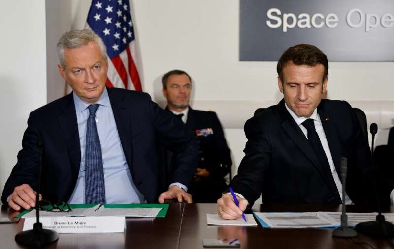 French Finance Bruno Le Maire (L) and French President Emmanuel Macron, attend a meeting with US Vice President Kamala Harris, n