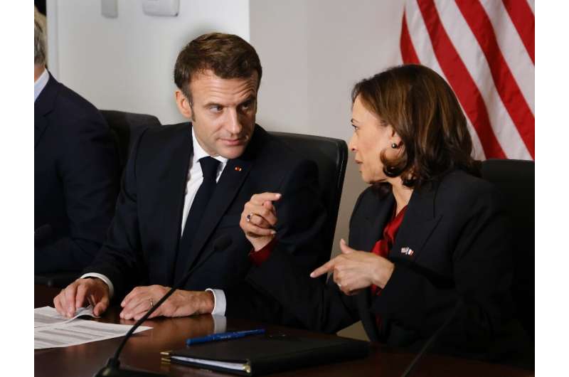 French President Emmanuel Macron speaks with US Vice President Kamala Harris at the National Aeronautics and Space Administratio