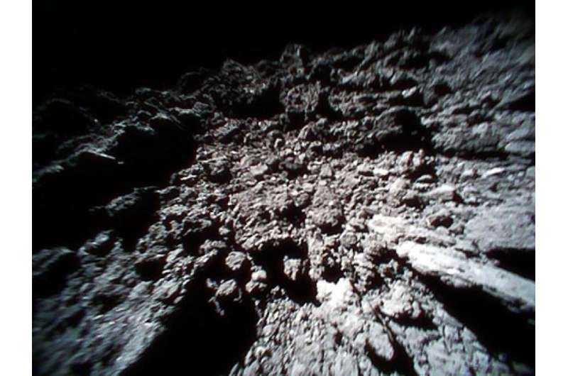 Hopping space dust makes asteroids look rougher