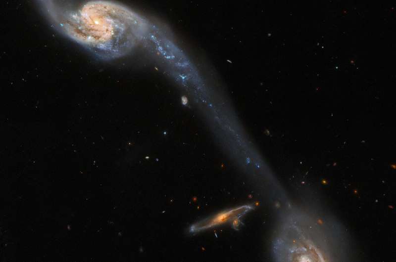 Hubble inspects two galaxies connected by a luminous bridge