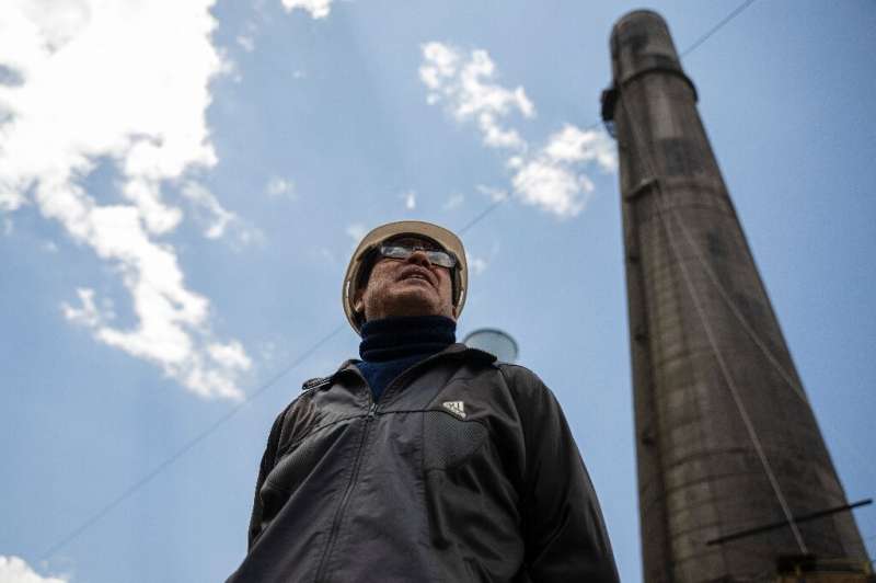 Jose Aguilar, head of human resources at the new metallurgical company, stands in front of a massive fireplace he hopes