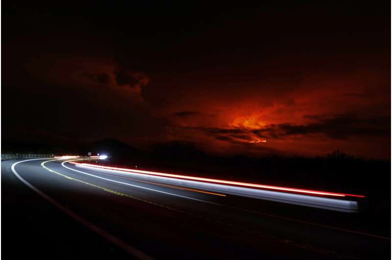Lava from Hawaii volcano lights night sky amid warnings