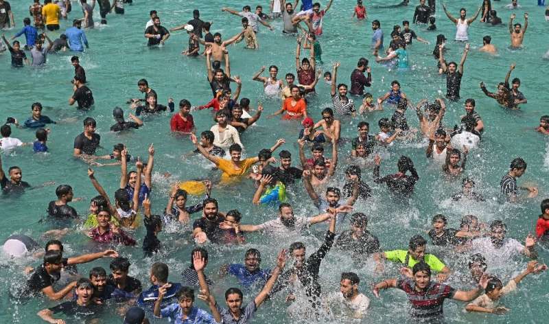 Men cool off at a swimming pool during the heatwave in Lahore, Pakistan on April 28, 2022