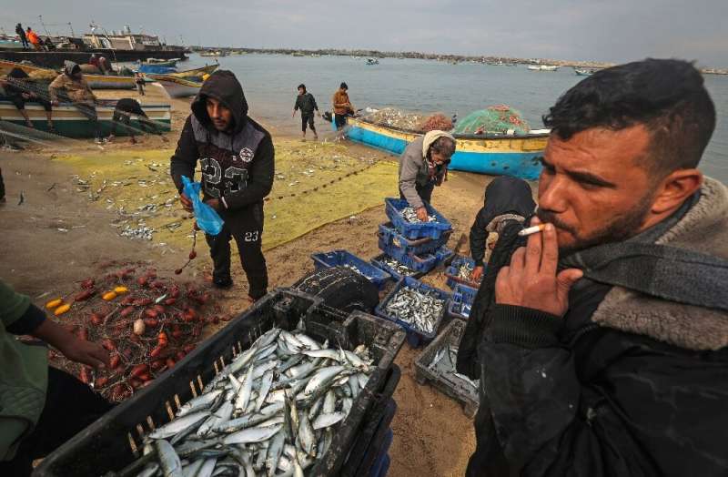 Palestinian fishermen on the beach in Gaza on January 29, 2022