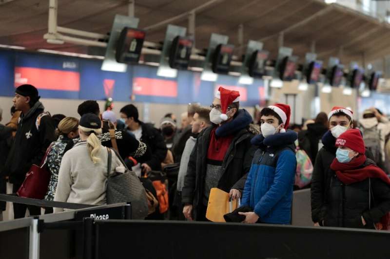 Passengers queue up to go through security at Detroit Metro Airport in Romulus, Michigan, on December 22, 2022