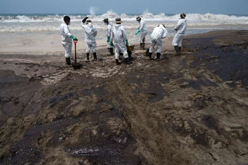 Peruvian soldiers help clean up one of around 20 beaches affected by the oil spill blamed on Spanish energy giant Repsol