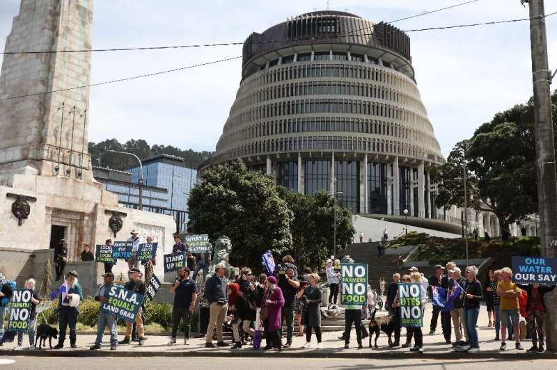 Protestors against the government's plans to tax emissions from farm animals gather outside New Zealand's parliament in Wellingt