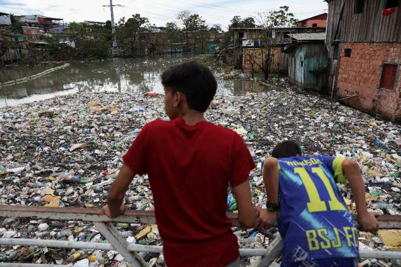 Residents of Manaus, Brazil's largest metropolis in the Amazon rainforest, look out over a river of trash -- a common occurrence