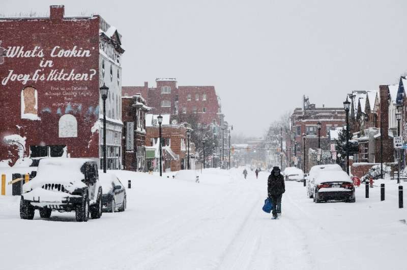 Residents walk along snow-covered streets in Buffalo on December 26, 2022
