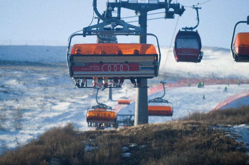 Skiers take a ski lift at the Genting Snow Park