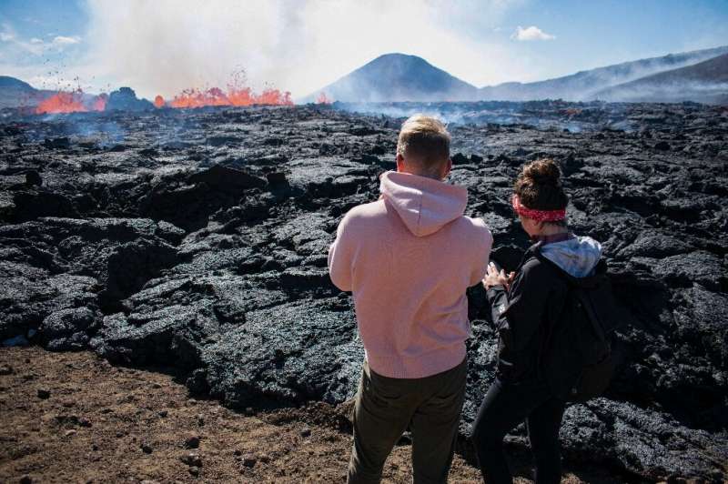 Some intrepid visitors walk right up to the cooling magma