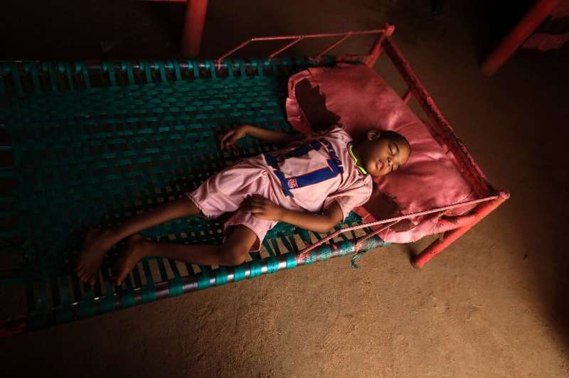 Talab, the youngest child of Awadya Ahmed, lies on a bed in the village of Banat in River Nile state, north of the Sudanese capi