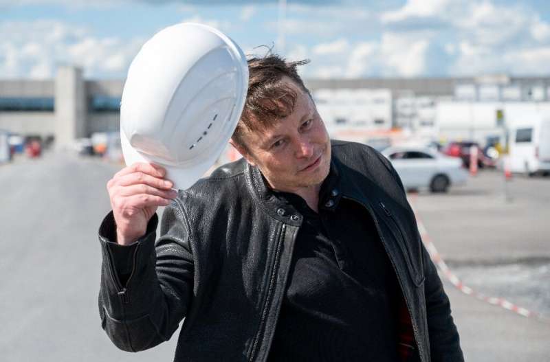 Tesla CEO Elon Musk tips his hard hat