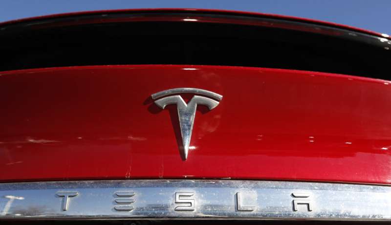 Tesla posts record profit, won't produce new models in 2022