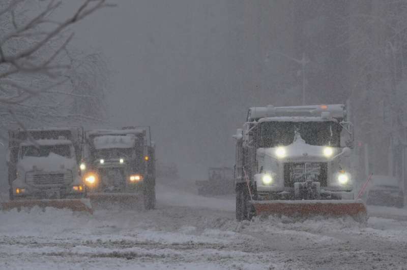 Trucks plow snow during a winter storm over the capital region on January 3, 2022 in Washington