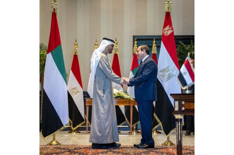 UAE President Sheikh Mohamed bin Zayed al-Nahyan, on the left, and Egypt's President Abdel Fattah el-Sisi shake hands after a ce