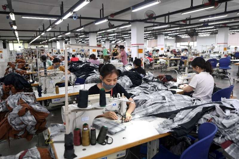 Vietnamese workers at a Hanoi factory which makes clothes for various brands
