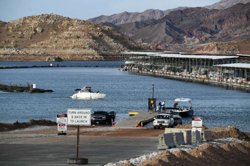 Visitors launch boats from a ramp extended multiple times as a result of worsening low water levels due to the western drought a