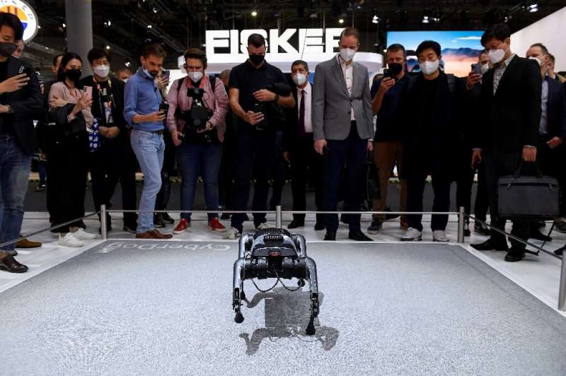 Visitors look at the Cyberdog robot, cost  a cool $1,600, on Xiaomi's stand at the Mobile World Congress