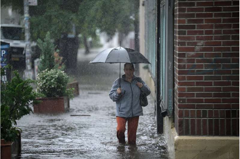 A Brookly resident walks through floodwaters in the New York borough
