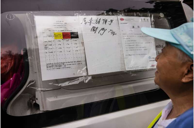 A colour-coded system for heat guidelines is displayed on the side of a van in Hong Kong