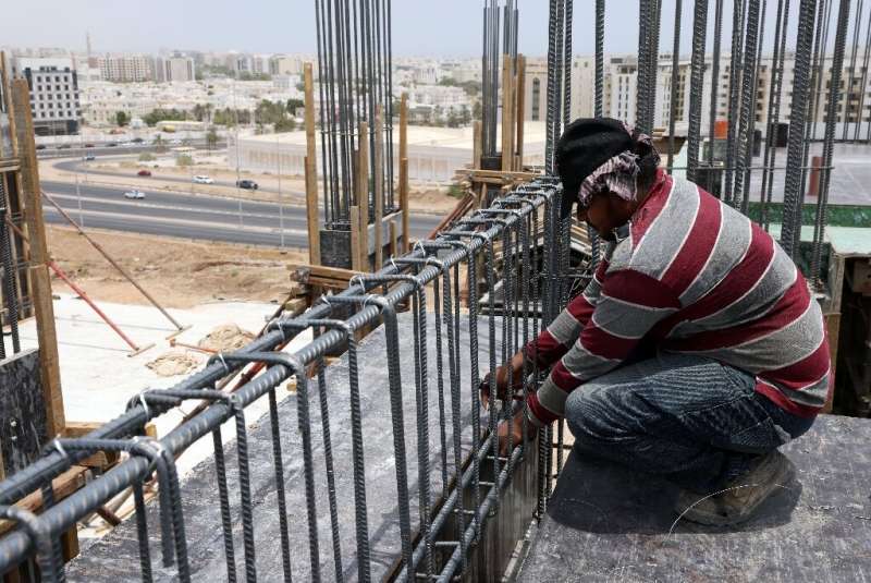 A foreign labourer toils in the heat on a construction site in the Omani capital Muscat