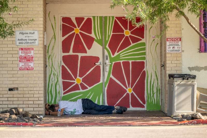 A homless person lies in the shade during the heat wave in Phoenix, Arizona, in July 2023