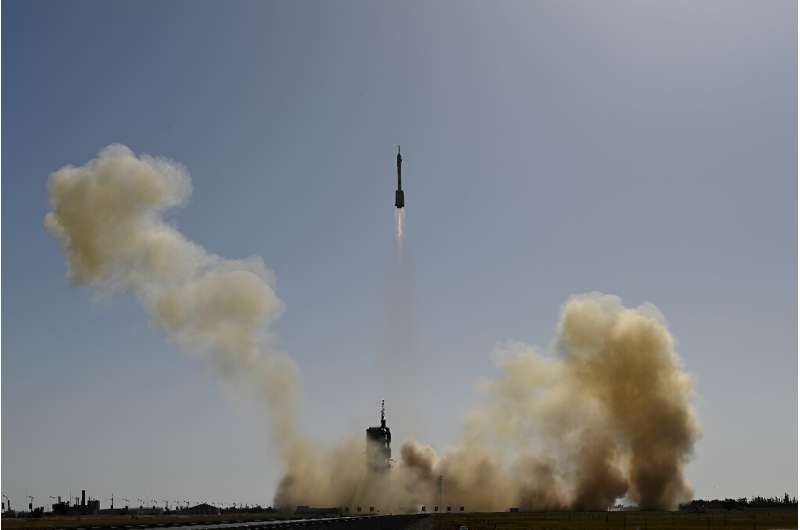 A Long March-2F carrier rocket, carrying the Shenzhou-17 spacecraft and a crew of three astronauts, lifts off from the Jiuquan Satellite Launch Centre
