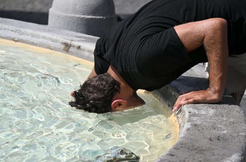 A man cools off in a fountain in Rome as Europe braces for new high temperatures