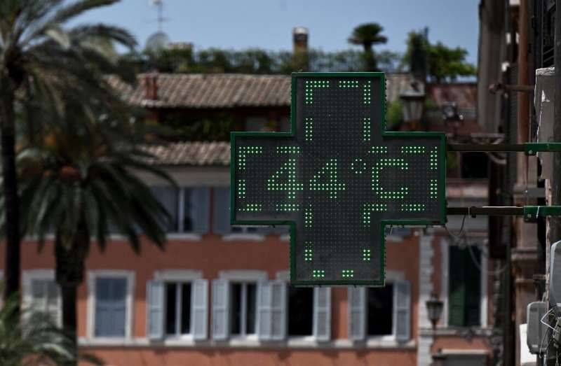A pharmacy sign flashes 44C near the Spanish Steps in Rome