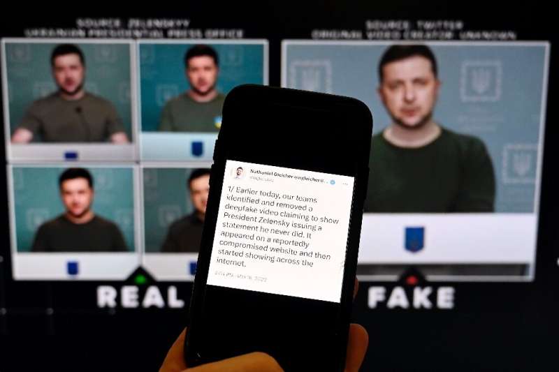 A phone shows a statement from the head of security policy at Meta in front of a fake video of Ukrainian President Volodymyr Zel