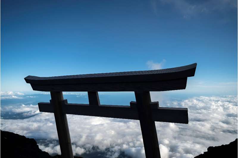 A &quot;tori&quot; or gate to mark the arrival at the summit of Mount Fuji, some 70 kilometres (43 miles) west of the capital Tokyo Climbing Mount Fuji is no easy feat, but spectacular sunrise views above a sea of clouds are a fine reward for those who ta