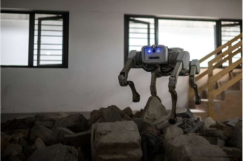 A robot dog tramples over rubble in a demonstration