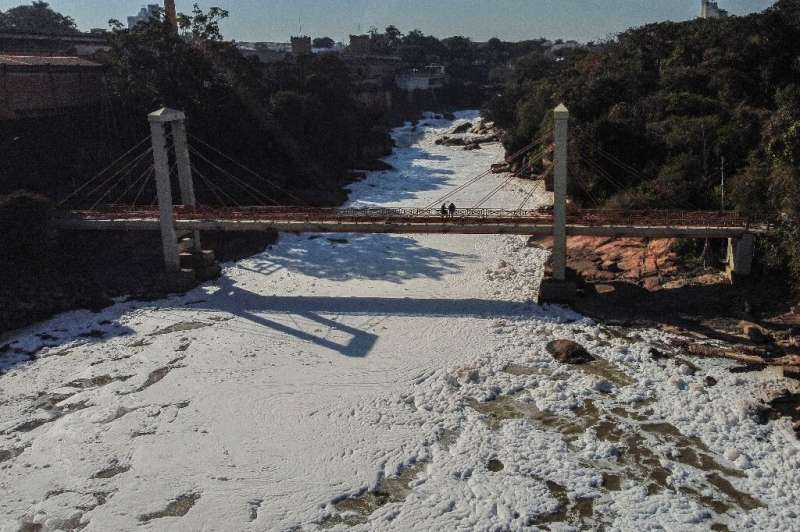 A tributary of the Parana river, the Tiete river is covered in a visible foam