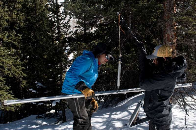 A tube used to take a core A tube used to take a core sample of the Colorado snowpack is hitched it to a portable scale dangling