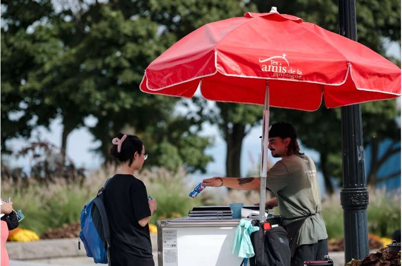 A woman buys ice cream during an unusual autumn heatwave in Montreal