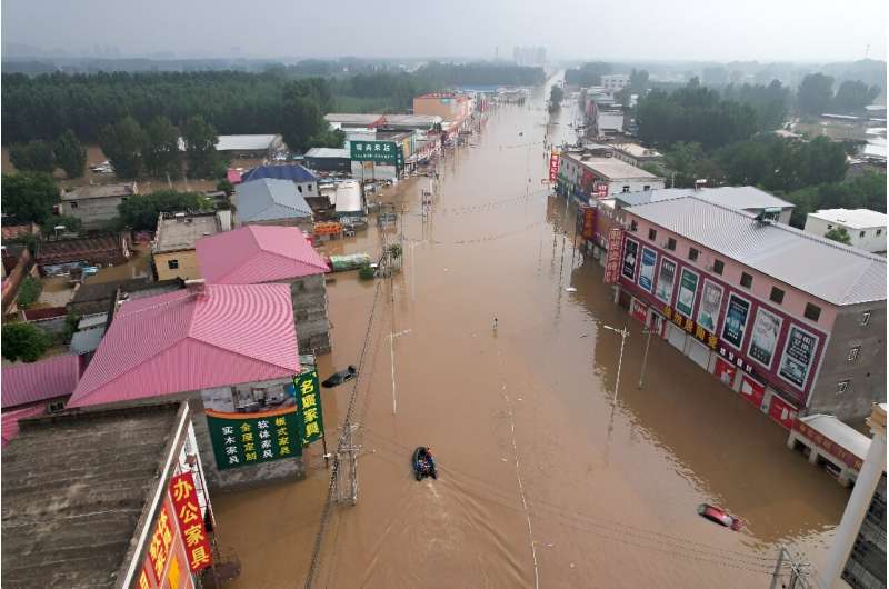 Aerial photographs taken by AFP of the province's Zhuozhou city showed shopping streets turned into rivers of brown water